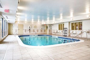 An indoor swimming pool with clear lane markings, a lifeguard chair, and a sign indicating the pool's depth. - Hampton Inn St. Joseph (St. Joseph)