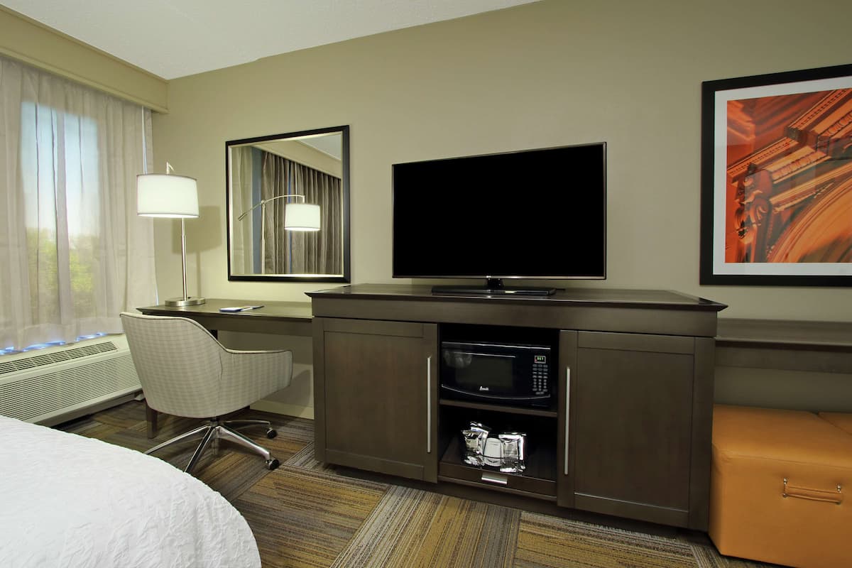 Desk, laptop workspace, blackout drapes, iron/ironing board