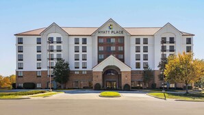 A multi-story hotel with a central entrance, a brick facade, and a clear sky. - Hyatt Place Kansas City/Overland Park/Convention Center (Overland Park)