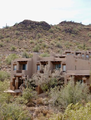 A desert-style building with multiple rooms and a view of a rocky hill in the background. - Inn at Eagle Mountain (Fountain Hills)