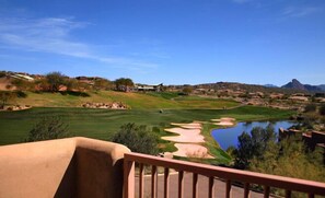 A golf course with a pond, a clubhouse, and a mountainous backdrop. - Inn at Eagle Mountain (Fountain Hills)