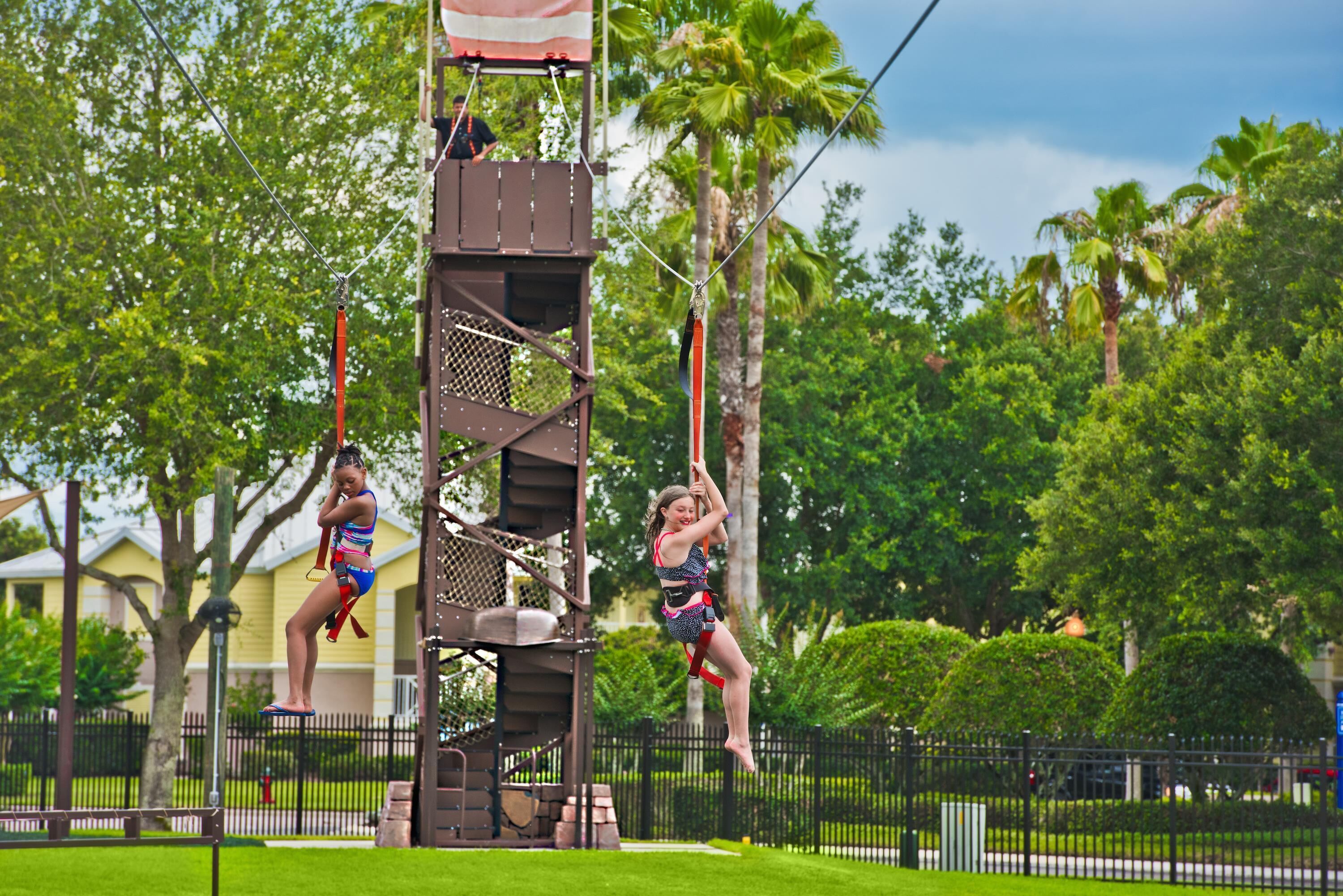 A zip line attraction with a metal tower and safety railings.