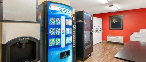 A room with a Pepsi vending machine, an Ice-O-Matic machine, and a white cabinet.