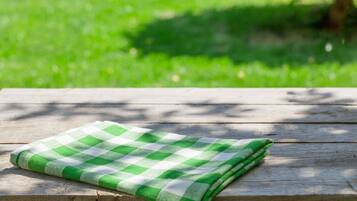A green and white checkered cloth on a wooden surface.