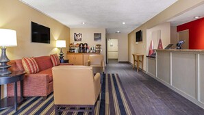 A hotel lobby with a sofa, armchairs, a coffee station, a reception desk, and a TV mounted on the wall. - Extended Stay America Suites San Antonio Colonnade Medical (San Antonio)