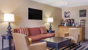 A hotel room with a sofa, two armchairs, a coffee station, and a TV on the wall. - Extended Stay America Suites San Antonio Colonnade Medical (San Antonio)