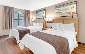 A hotel room with two beds, a large window with curtains, and abstract paintings on the wall. - Extended Stay America Suites Asheville Tunnel Rd (Asheville)