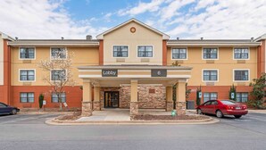 A hotel with a lobby entrance, numbered 6, and a parking sign. - Extended Stay America Suites Asheville Tunnel Rd (Asheville)