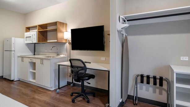 A compact kitchenette with a microwave, refrigerator, and sink. - Extended Stay America Select Suites - Charlotte - University Place (Charlotte)