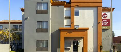 A Best Western Plus hotel with a modern design, featuring a central entrance, multiple windows, and a parking lot.