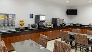 A breakfast bar with coffee machines, a microwave, and a TV mounted on the wall. - Best Western Plus Fresno Inn (Fresno)
