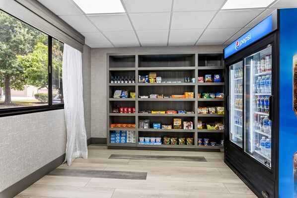 A vending machine area with snacks, drinks, and a Pepsi refrigerator.