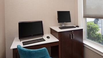A workspace with a desk, two monitors, a keyboard, and a mouse.