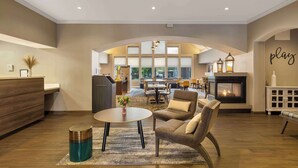 A spacious living area with a fireplace, comfortable seating, and a view of the outdoors.