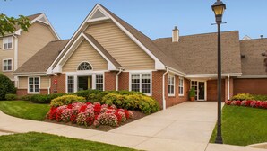 A two-story building with a brick facade, a pitched roof, and a front entrance. - Residence Inn By Marriott Columbia (Ellicott City)