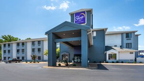 A Sleep Inn by Choice Hotels building with a modern design, featuring a prominent entrance and a parking area. - Sleep Inn Henderson-Evansville South (Henderson)