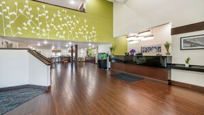 A spacious lobby with a reception desk, a staircase, and a large wall mural. - Sleep Inn Henderson-Evansville South (Henderson)