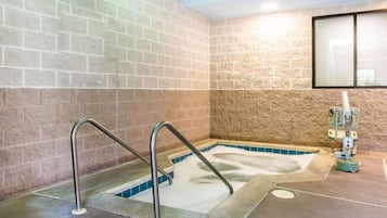 Relax in the hot tub surrounded by a tile surround and enjoy a soothing massage.