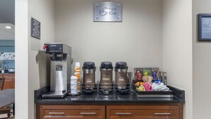 A coffee station with a Bunn coffee machine, three drip coffee makers, and various coffee pods and creamer bottles. - Sleep Inn Mt. Pleasant - Charleston (Mount Pleasant)