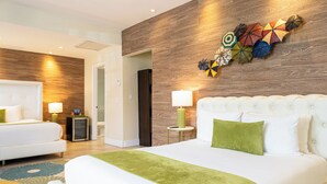 A hotel room with a large bed, a smaller bed, a wooden accent wall, and a decorative wall piece. - Chesterfield Hotel & Suites (Miami Beach)