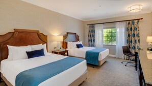 A hotel room with two beds, a desk, and a chair. - Ayres Suites Diamond Bar (Diamond Bar)