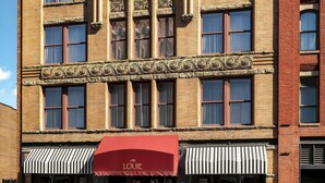 A historic building with a red awning labeled "LOUIE" and a modern storefront. - The Louie, A Davenport Hotel, Autograph Collection® (Spokane)