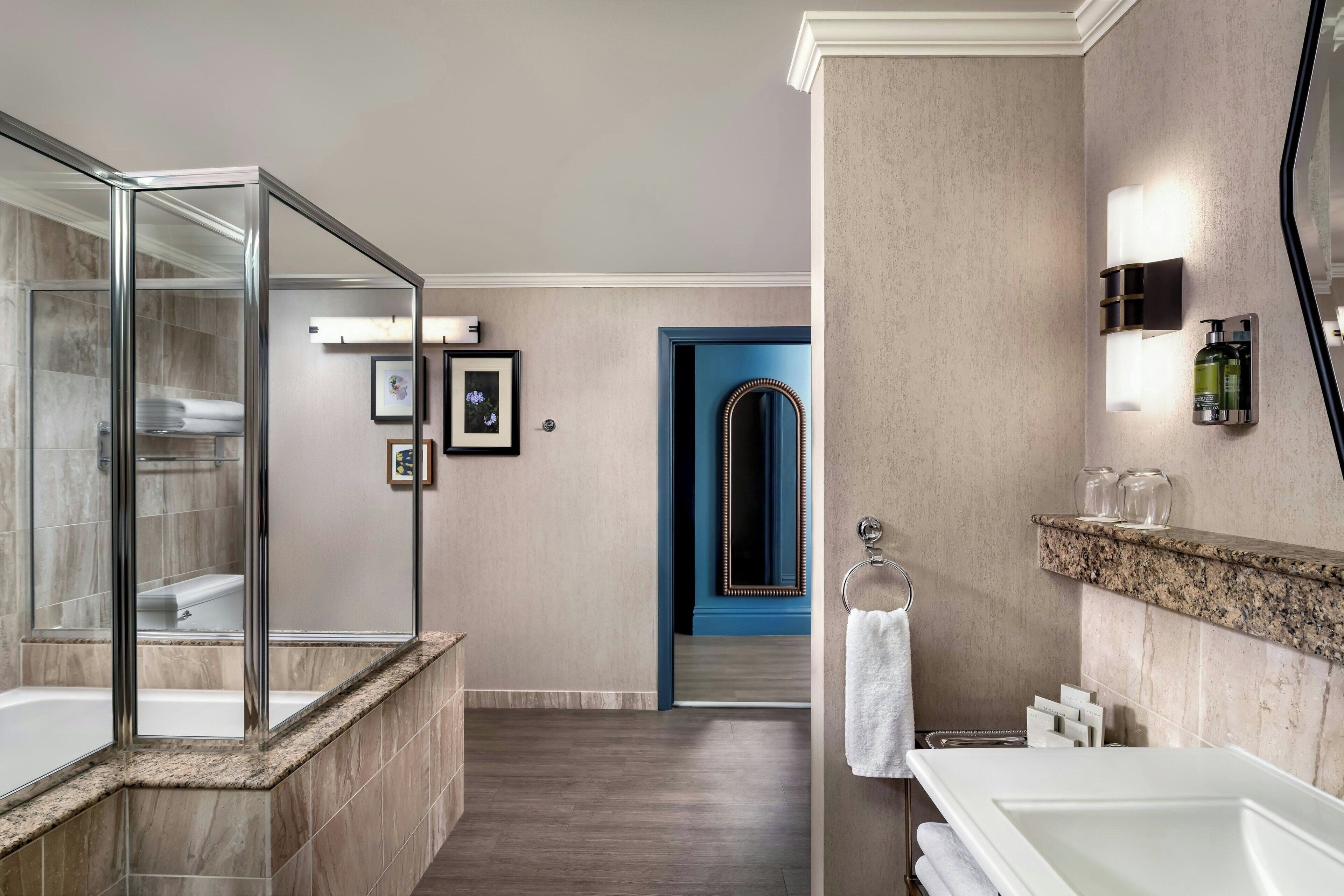 combined shower/bathtub, designer toiletries, hair dryer, towels