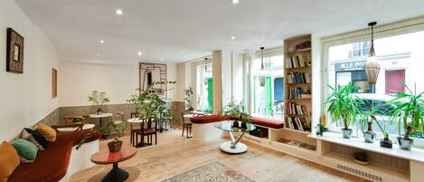 A modern living room with a sofa, a coffee table, and a bookshelf.