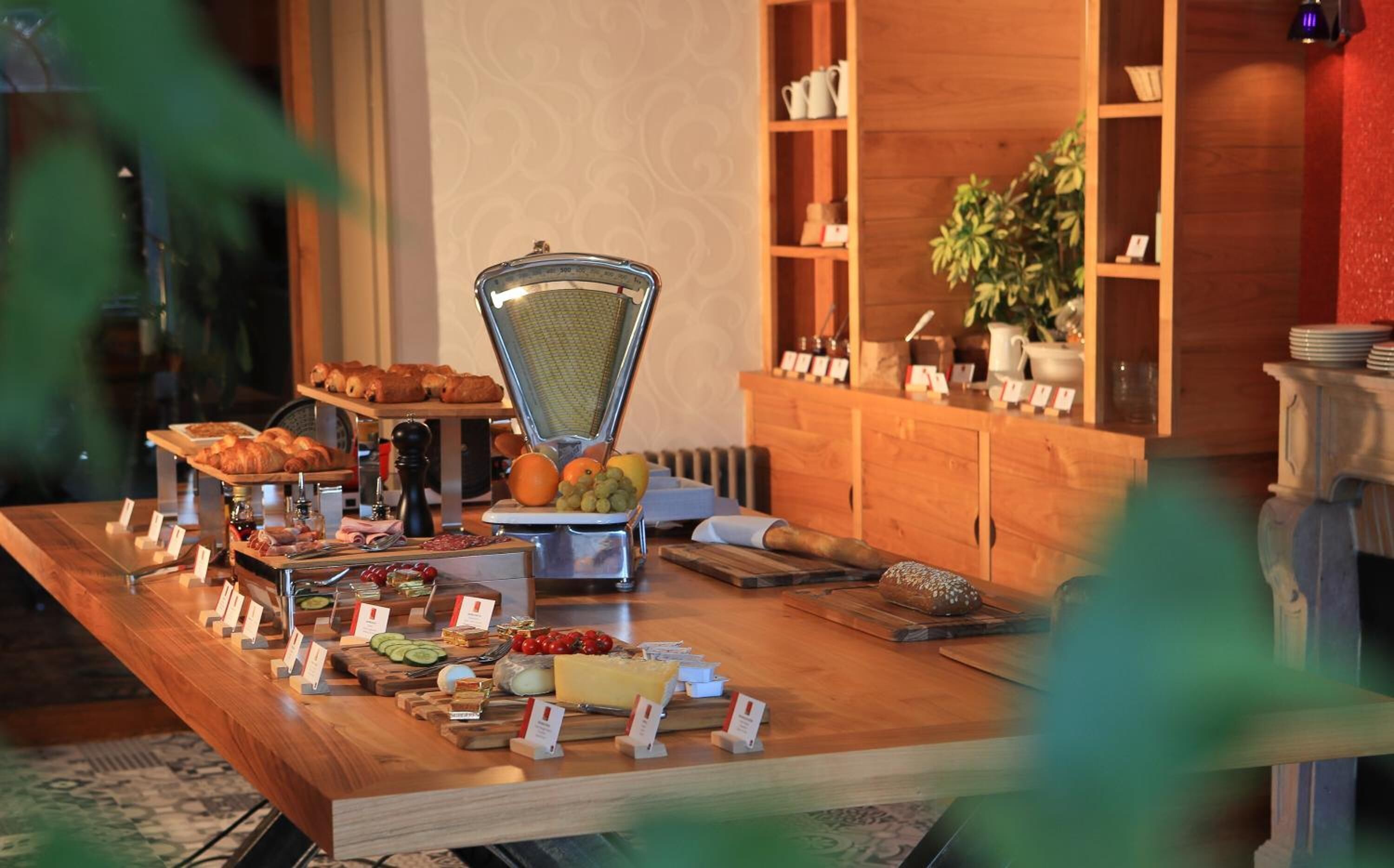 A buffet setup with various food items and a grater.
