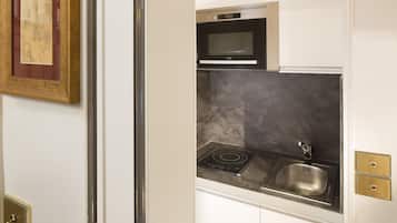 A kitchen with a microwave, stove, and sink.