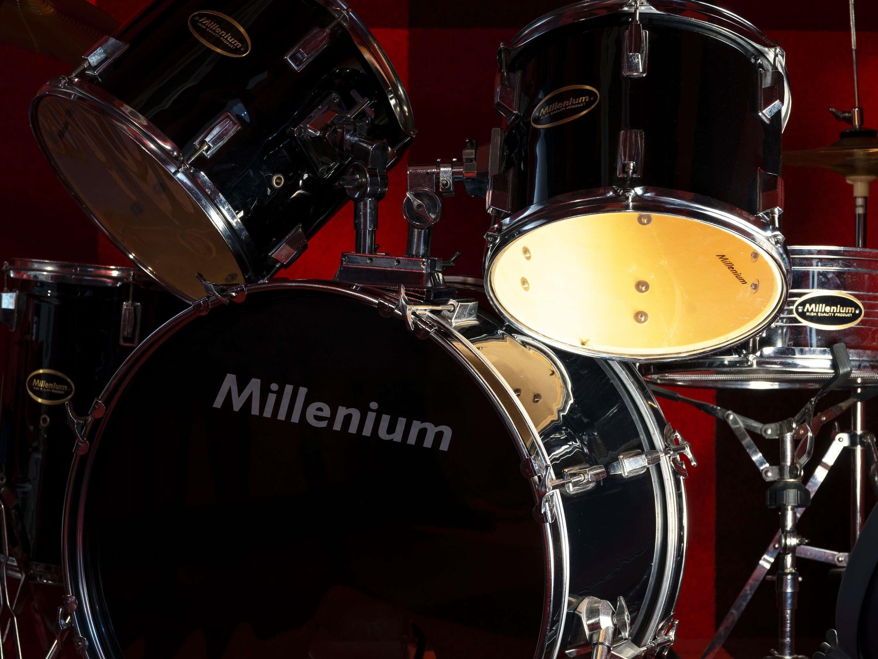 A drum set with the brand name 'Millennium' on the bass drum.
