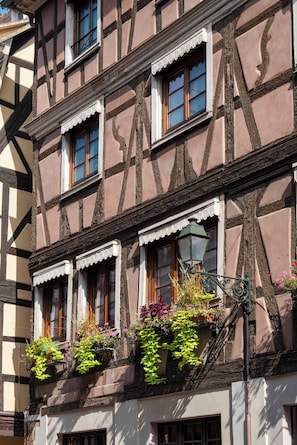 A traditional half-timbered building with multiple windows and flower boxes. - Hôtel de l'Europe by Happyculture (Strasbourg)