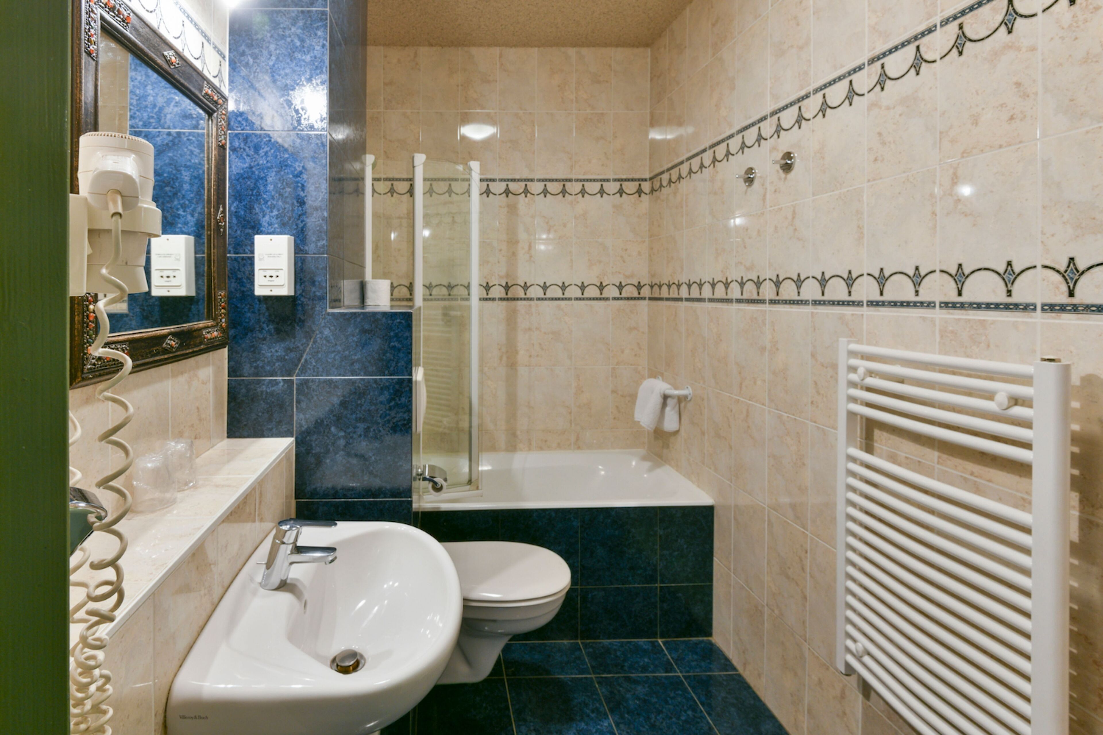 A bathroom with a sink, toilet, and bathtub.