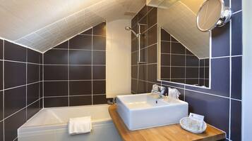 A modern bathroom with a bathtub, a sink, and a shower.