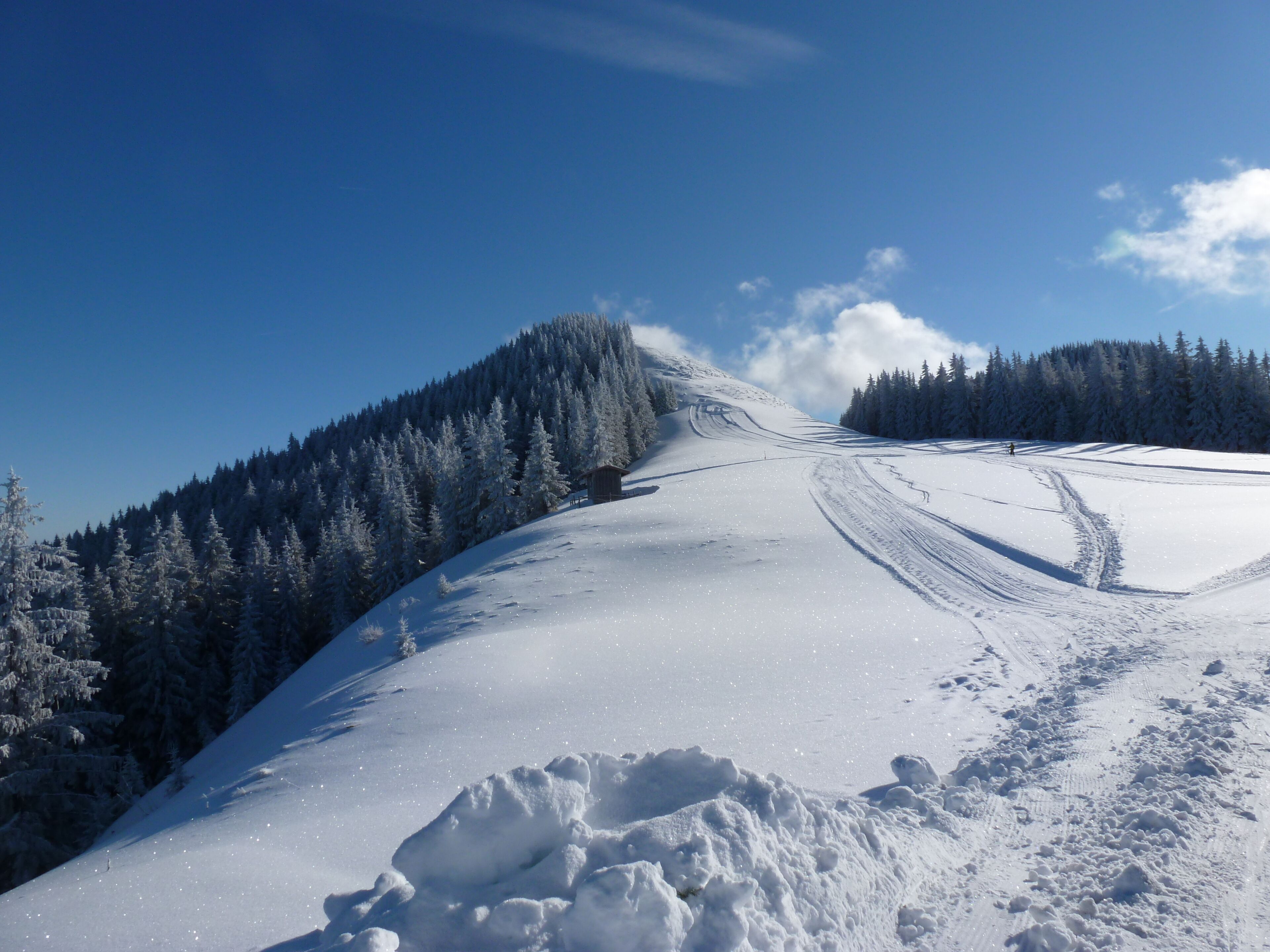 A snow-covered mountain landscape with a clear sky.