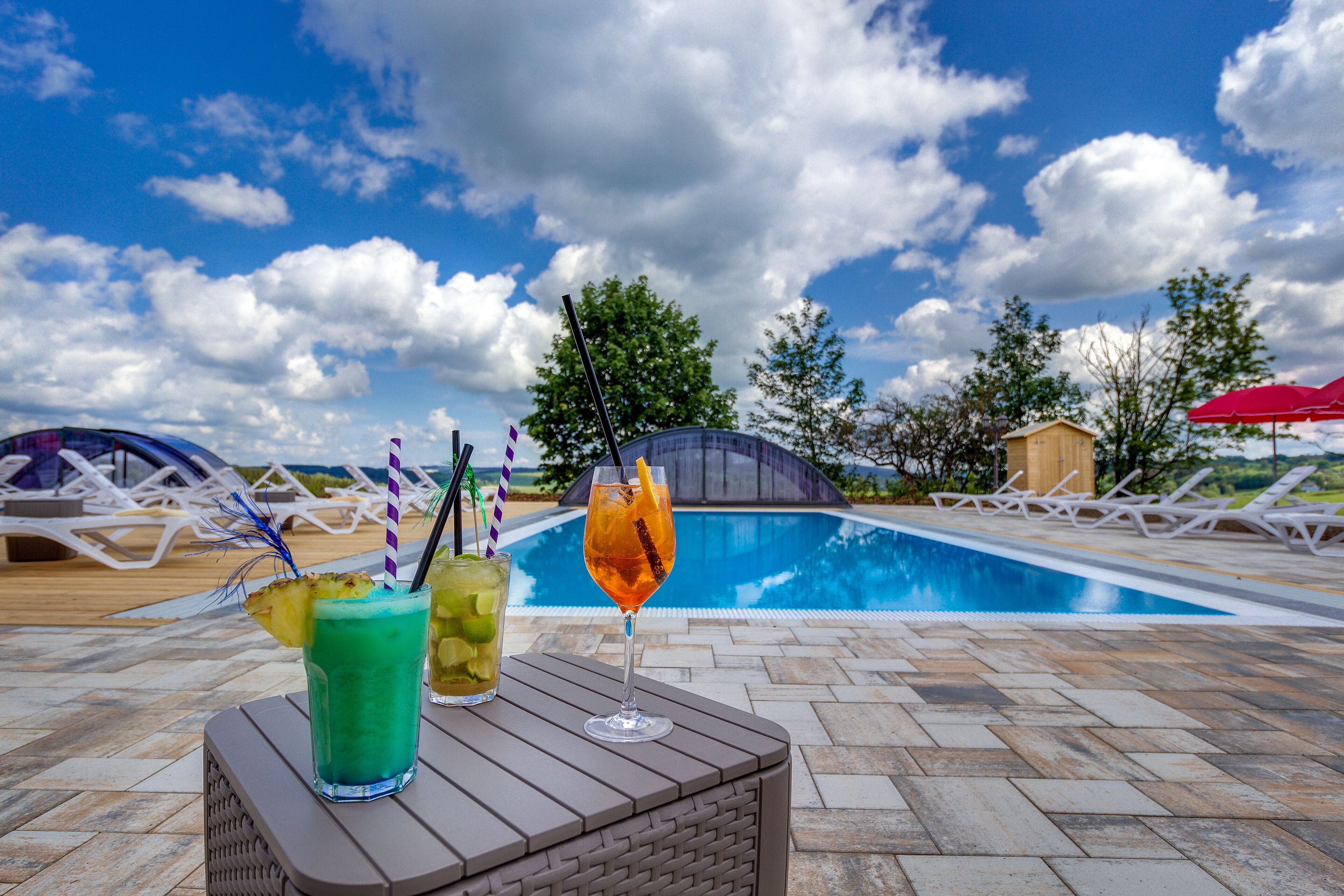 Seasonal outdoor pool, open 8:00 AM to 10:00 PM, pool umbrellas