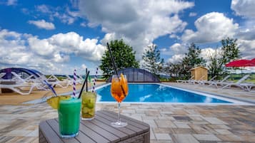 Seasonal outdoor pool, open 8:00 AM to 10:00 PM, pool umbrellas