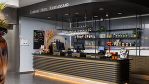 A modern hotel reception area with a counter, computer, and various amenities. - Comfort Hotel Kristiansand (Kristiansand)