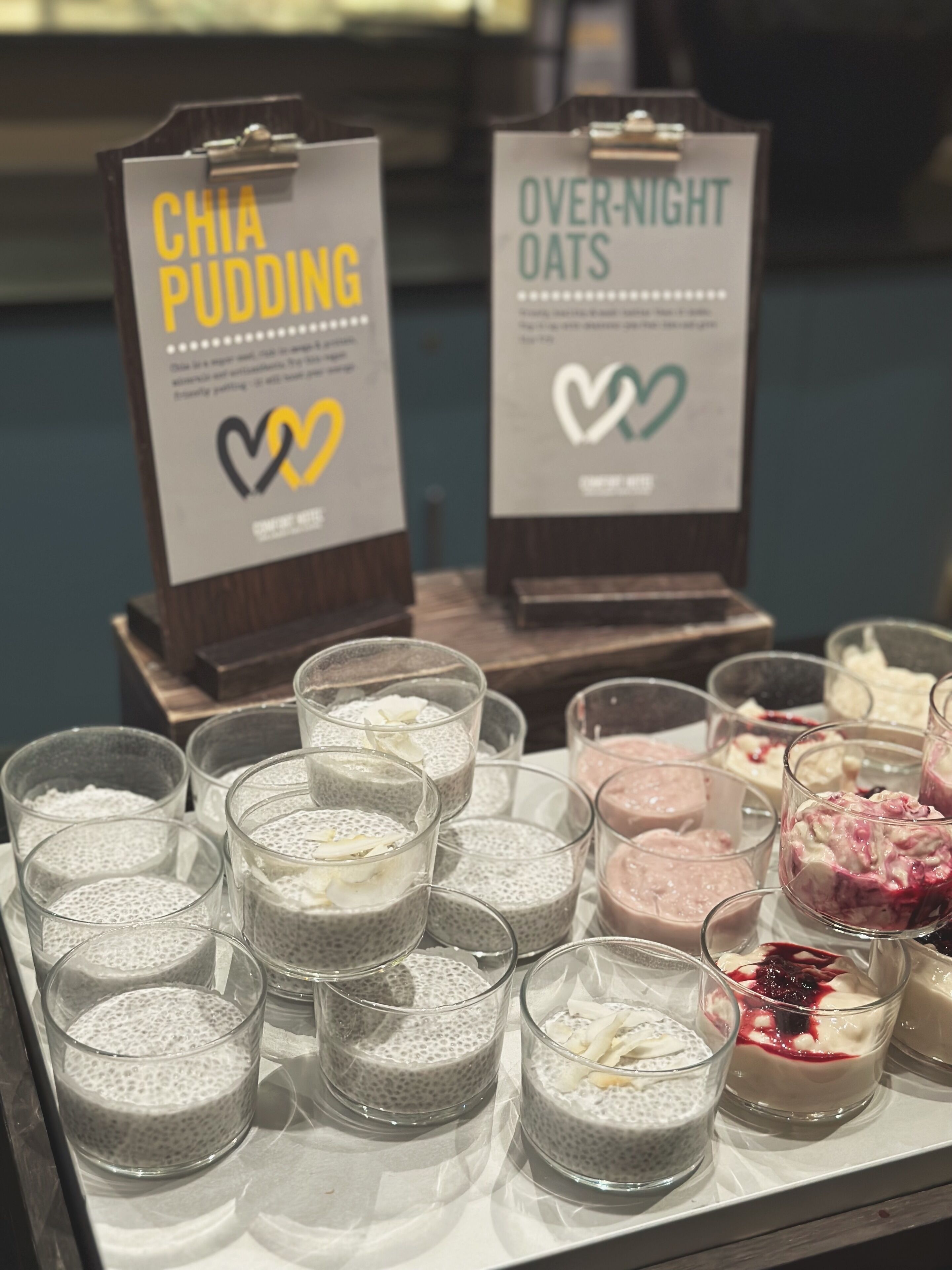 A display of chia pudding and over-night oats with labels and heart symbols.