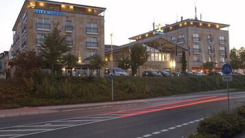 A CITY HOTEL with a modern design, featuring multiple floors and a prominent entrance.