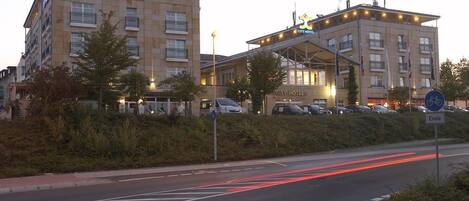 A CITY HOTEL with a modern design, featuring multiple floors and a prominent entrance.