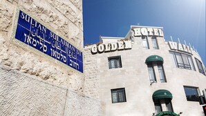A building with a sign for 'Sultan Suleiman St.' and 'Golden Waterfall Hotel'. - The Golden Walls Hotel (Jerusalem)