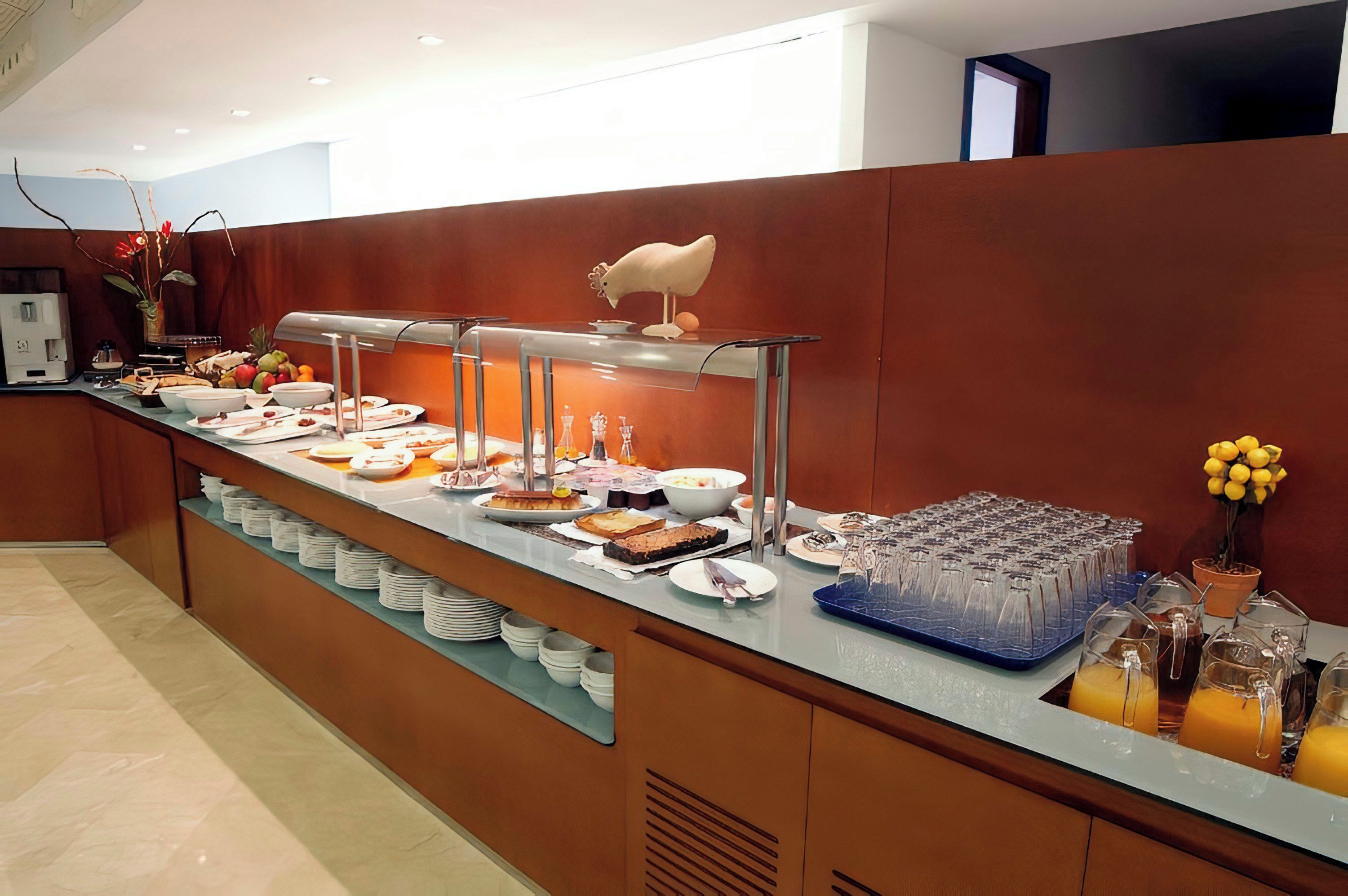 A buffet setup with various food items and a beverage station.