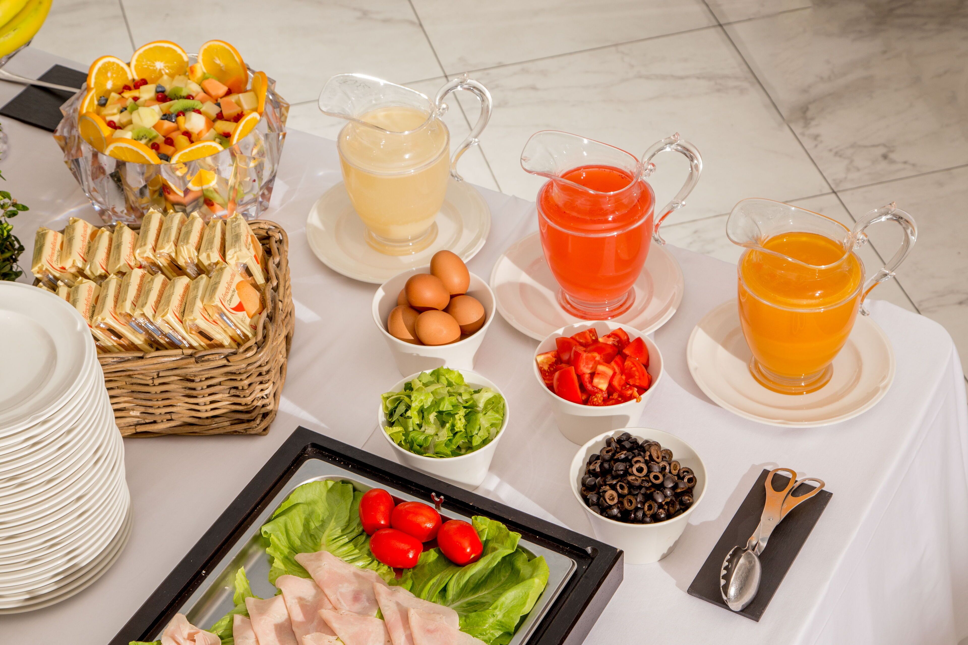 A breakfast buffet with various food items and drinks.