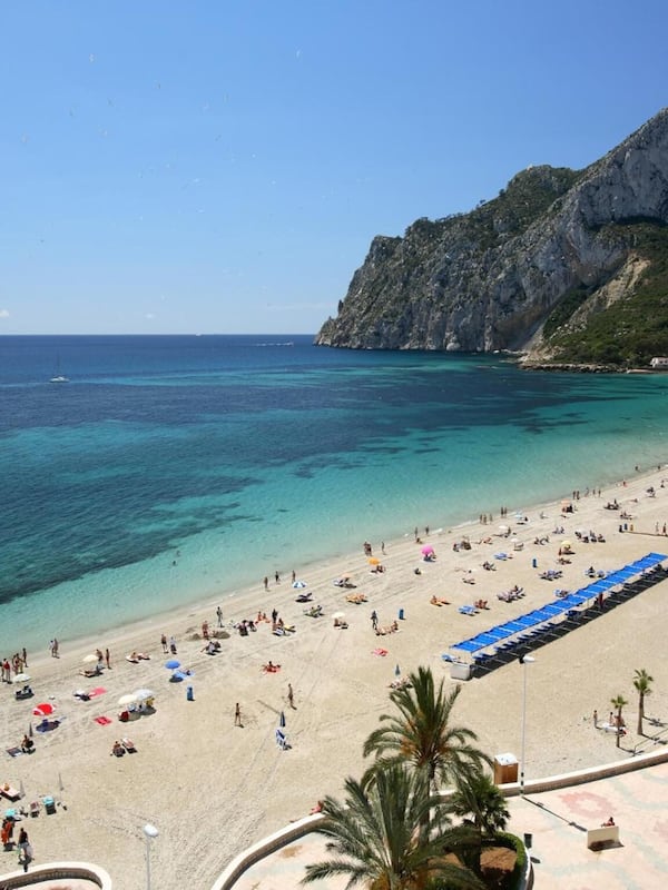 On the beach, white sand, sun loungers, beach umbrellas