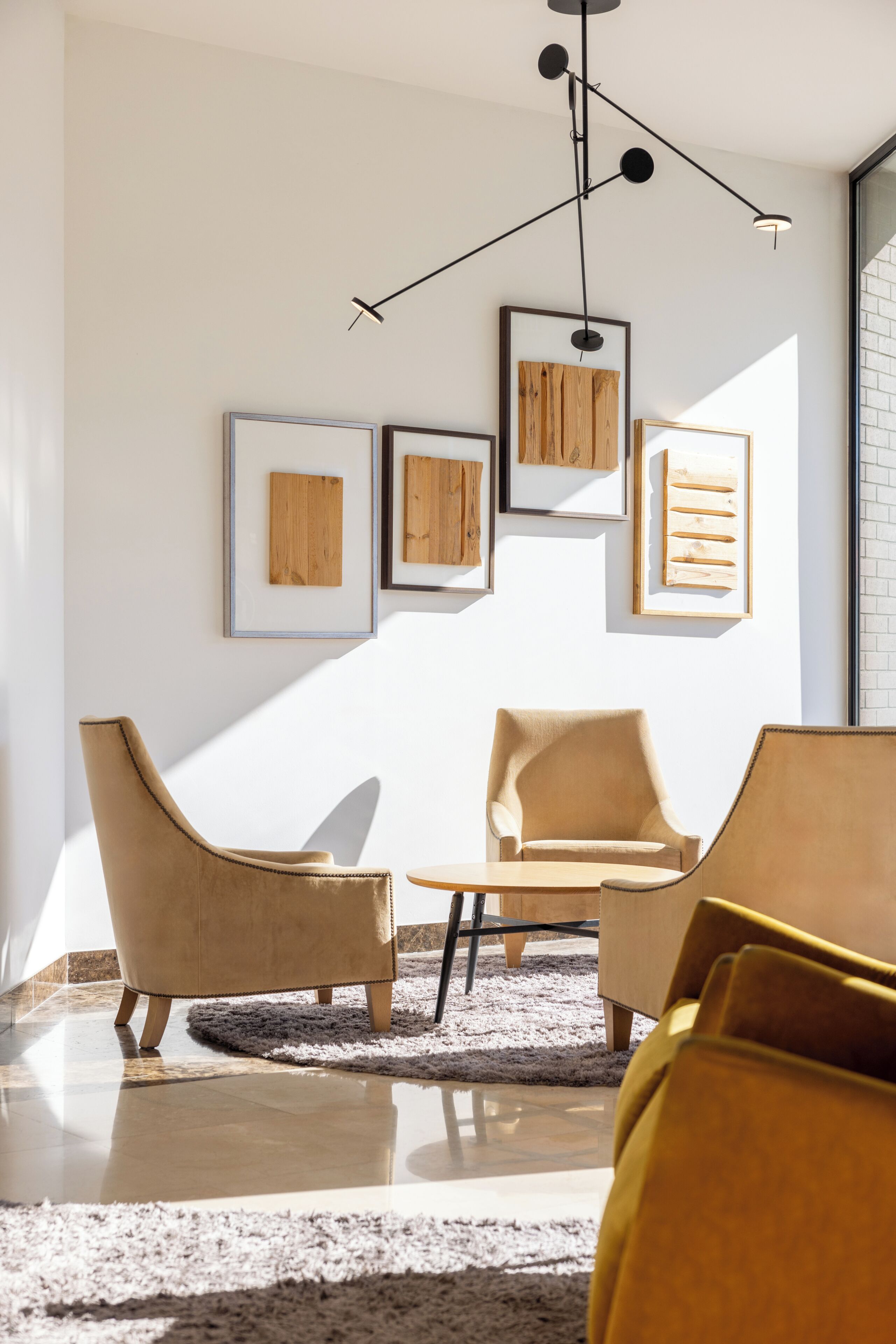 A modern living room with a sofa, a coffee table, and framed artwork on the wall.