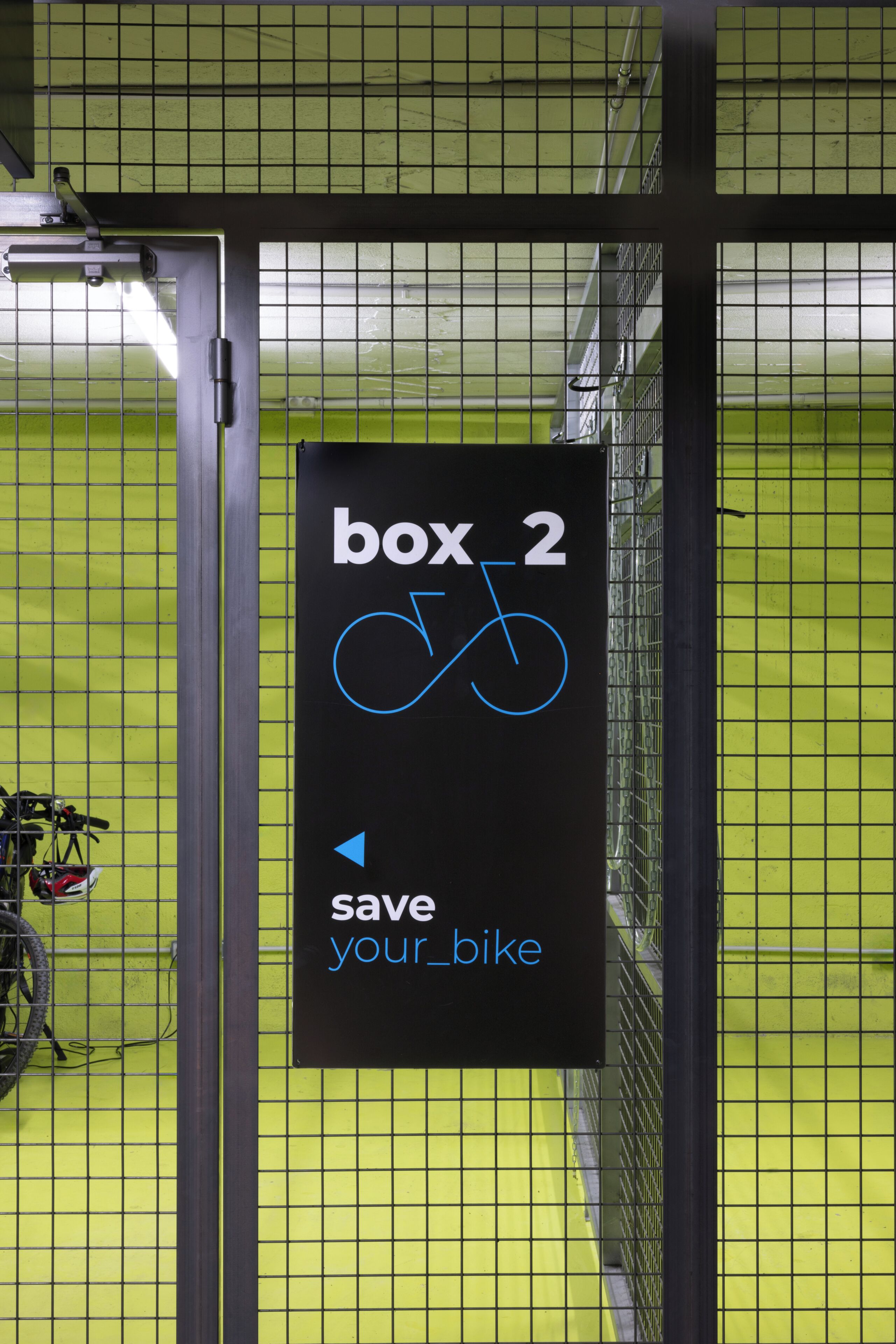 A sign indicating 'box 2' with a bicycle symbol and the text 'save your bike.'