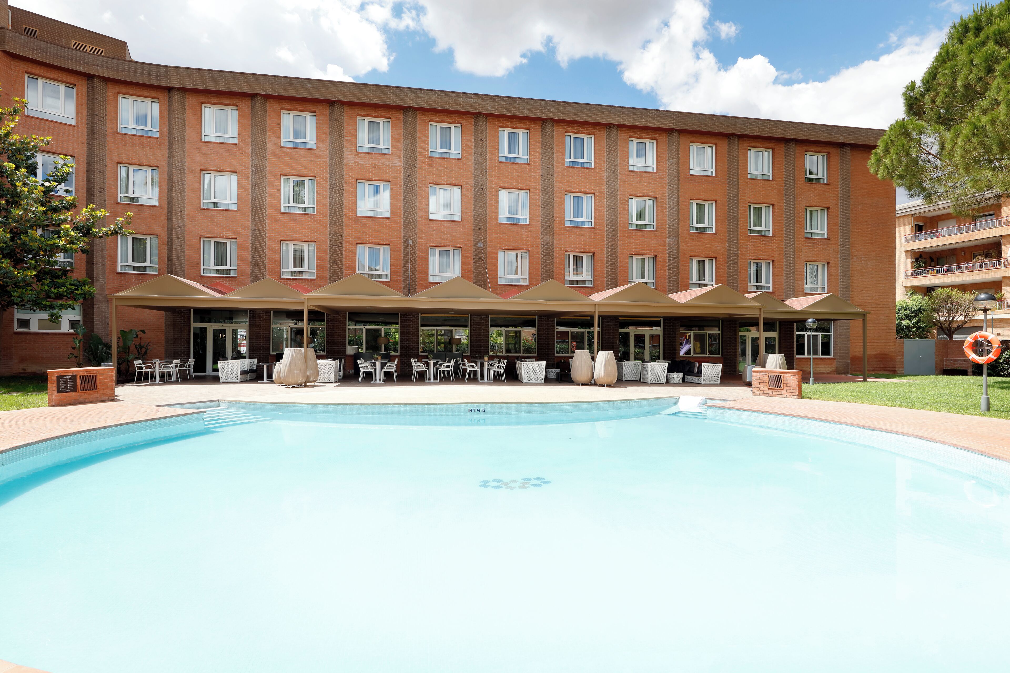 Seasonal outdoor pool, open 10:00 AM to 10:00 PM, pool umbrellas