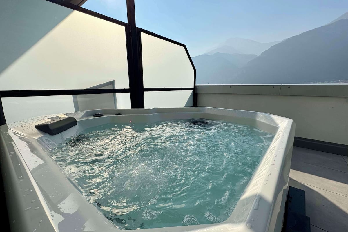 A hot tub with a view of mountains.