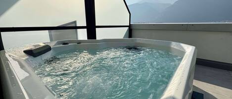 A hot tub with a view of mountains.